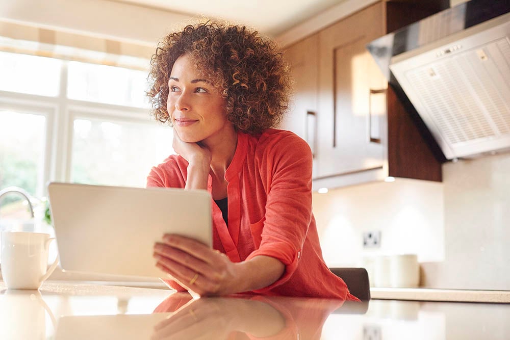woman in kitchen with tablet